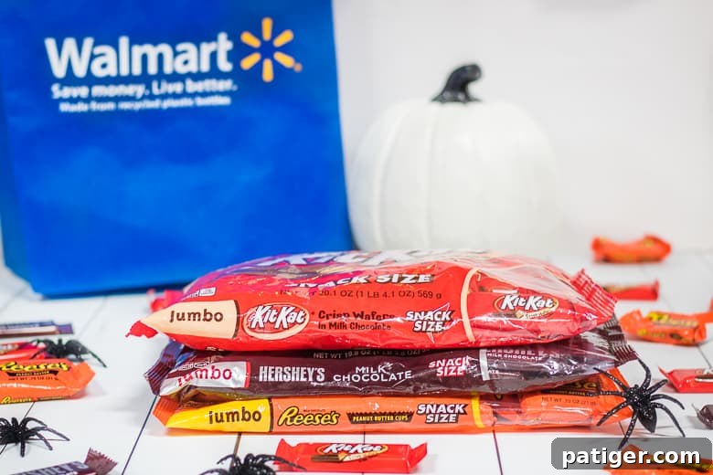 A close-up of an assortment of HERSHEY® Halloween Candy from Walmart, showcasing various popular chocolate bars and peanut butter cups, perfect for snacking or dessert creation.