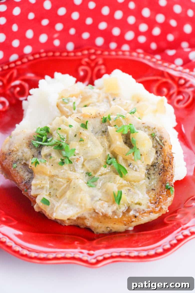 Smothered Pork Chops Recipe - A delectable one-pan dinner featuring juicy pork chops in a rich garlic onion gravy