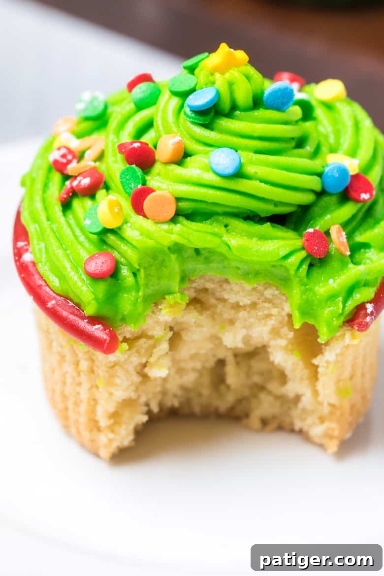 Christmas Tree Cupcakes with a bite taken out of the side, showing the vanilla cake