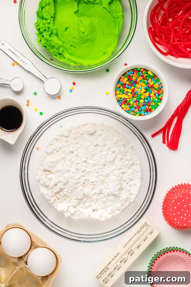 Assortment of Christmas Tree Cupcake Ingredients including flour, butter, sprinkles, and frosting