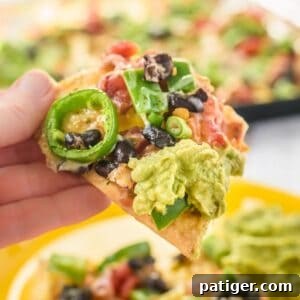 Vegetarian nachos with beans, peppers, cheese, and guacamole