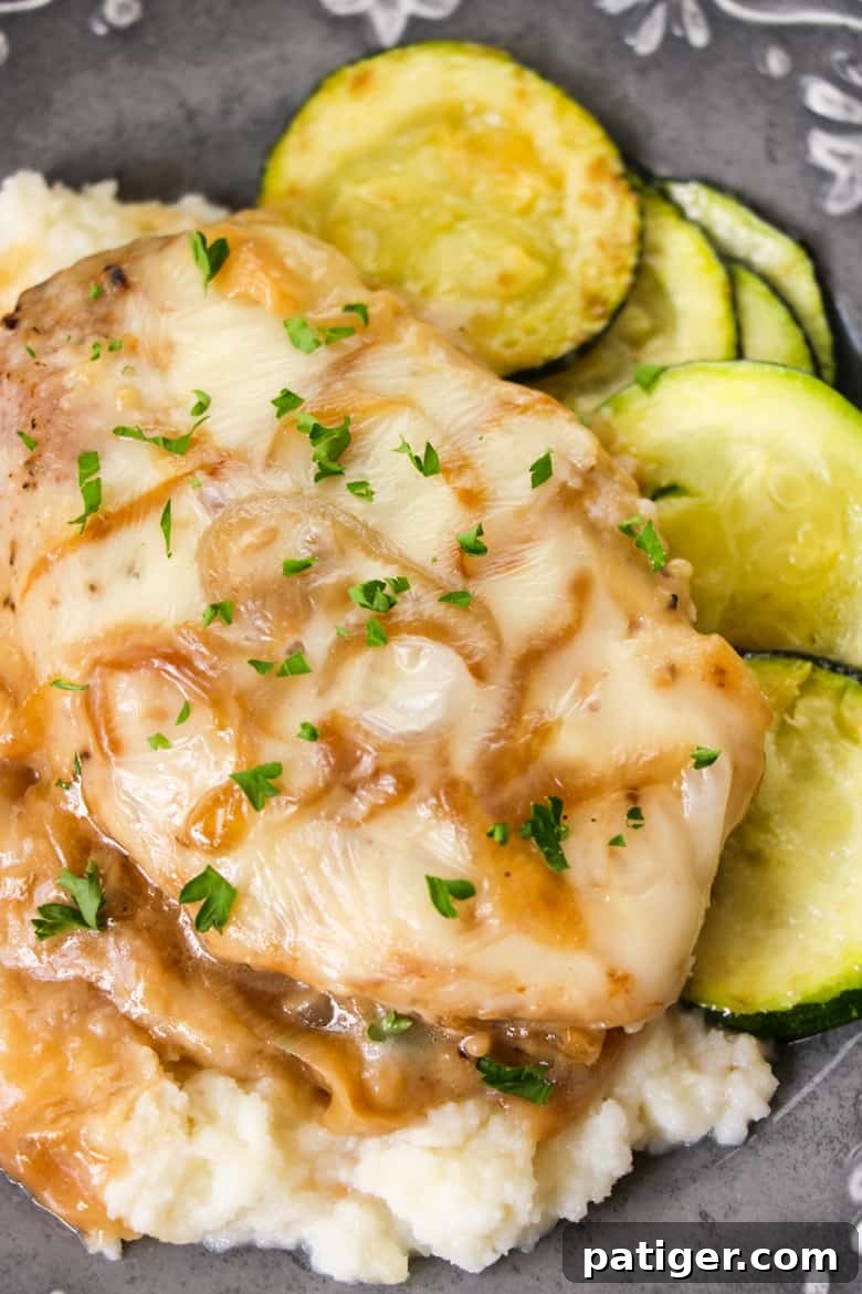 French Onion Smothered Pork Chops sizzling in a skillet