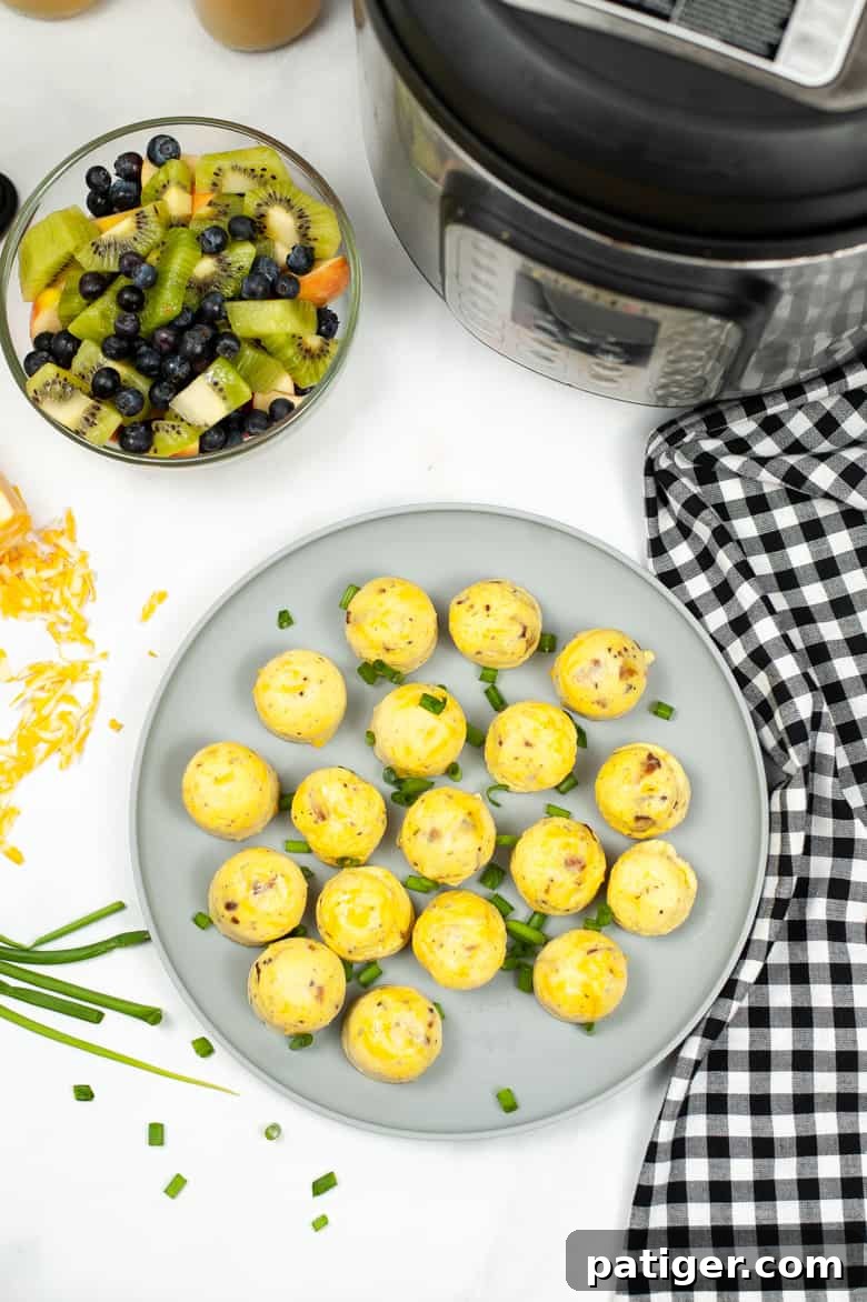 Copycat Starbucks Egg Bites on a grey plate with Instant Pot and fruit salad next to it