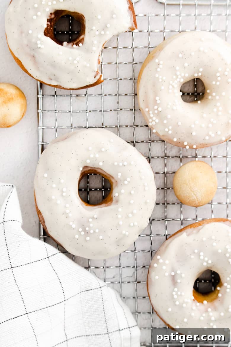 Homemade Air Fryer Doughnut Delights 12 A stunning shot of Air Fryer Vanilla Bean Donuts, glazed and ready to be served, highlighting their texture and appeal.