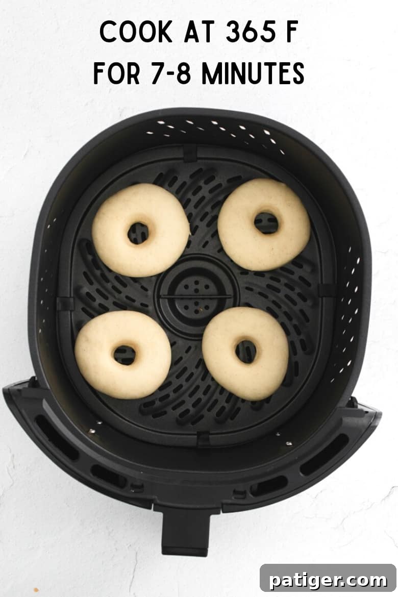 Homemade Air Fryer Doughnut Delights 9 Image showing donuts in an air fryer basket with text indicating to cook at 365 F for 7-8 minutes.