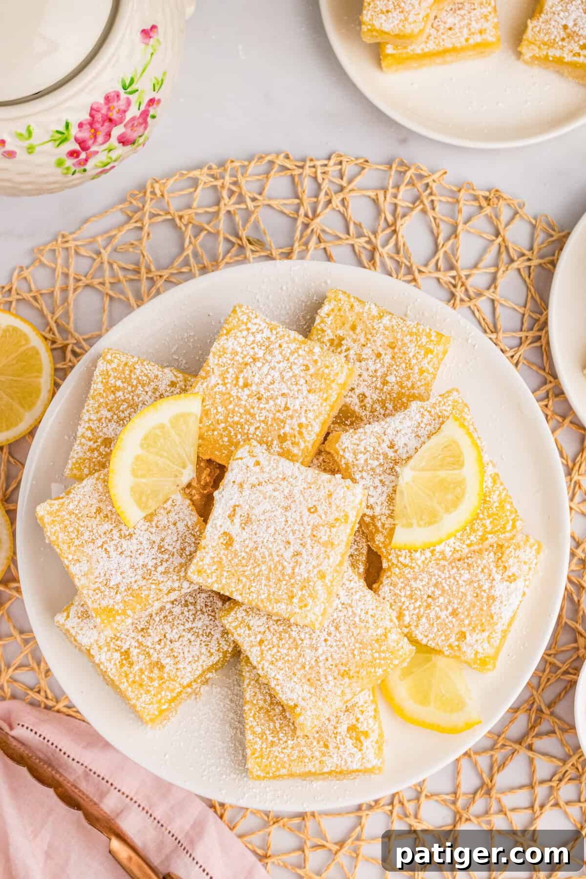 Plate with lemon square and lemon slice garnishes.