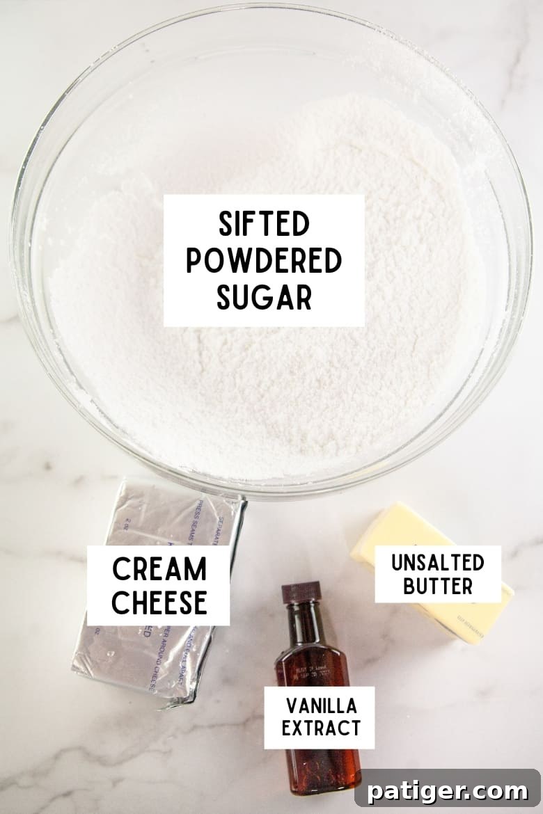 Cream cheese frosting ingredients: sifted powdered sugar, cream cheese, vanilla extract, unsalted butter laid out on a clean surface.