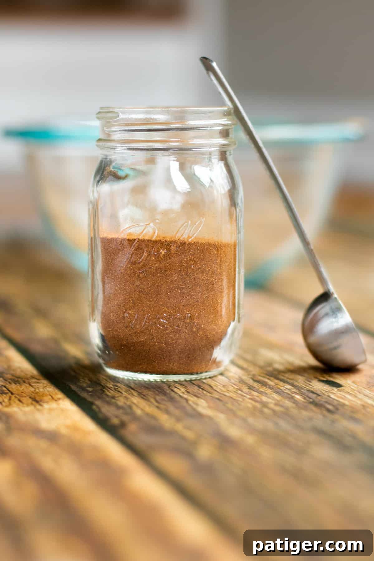 Autumn Orchard Spice 2 homemade apple pie spice in a small mason jar with small scoop next to it