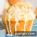 Zesty Lemon Poppy Seed Muffins 7 Lemon poppy seed muffin drizzled with lemon glaze which is dripping down the sides