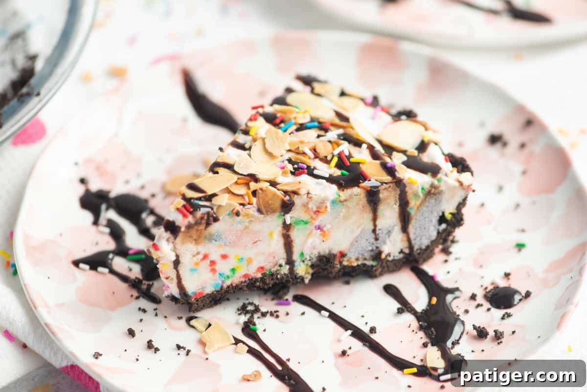 Icebox Indulgence 5 Slice of ice cream pie drizzled with chocolate sauce and topped with sprinkles and sliced almonds