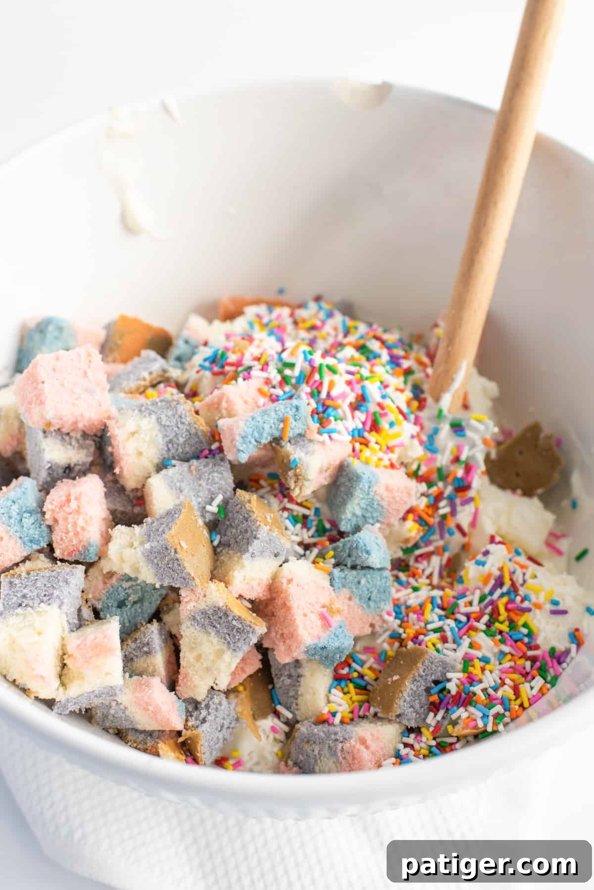 Icebox Indulgence 7 Mining bowl filled with vanilla ice cream, rainbow sprinkles, and chunks of cake