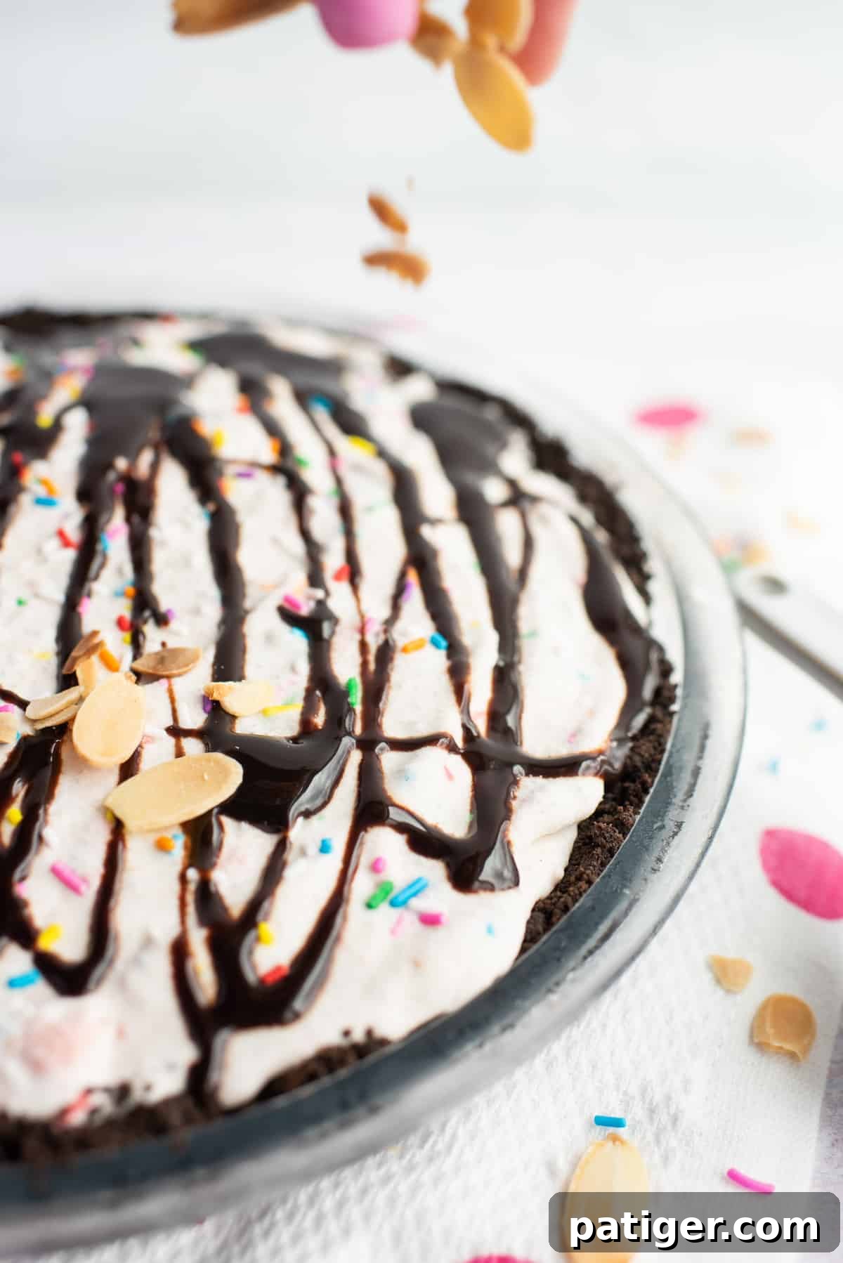 Icebox Indulgence 9 sliced almonds being sprinkled onto top of ice cream pie