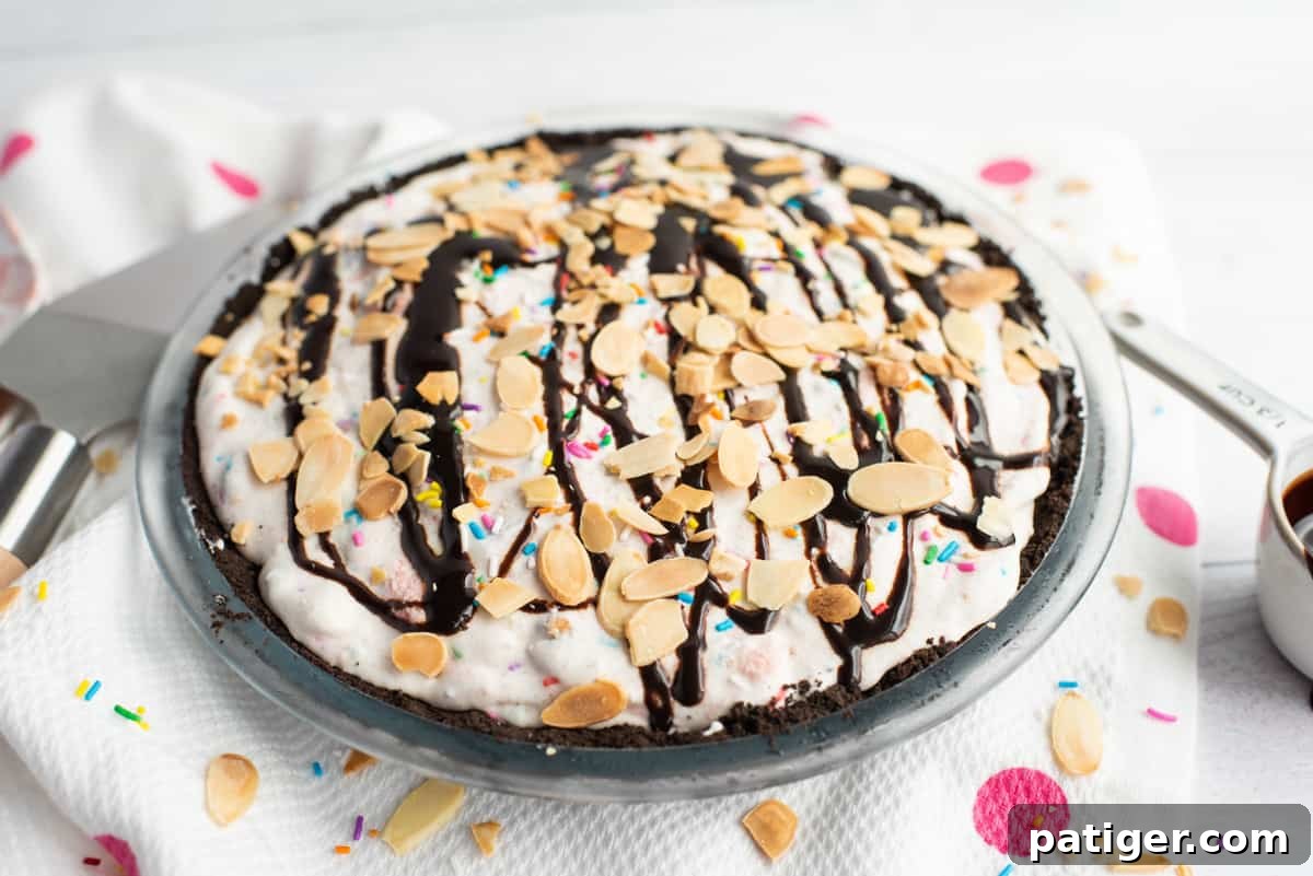 Icebox Indulgence 10 Pie topped with ice cream sundae toppings: sprinkles, chocolate sauce, and sliced almonds