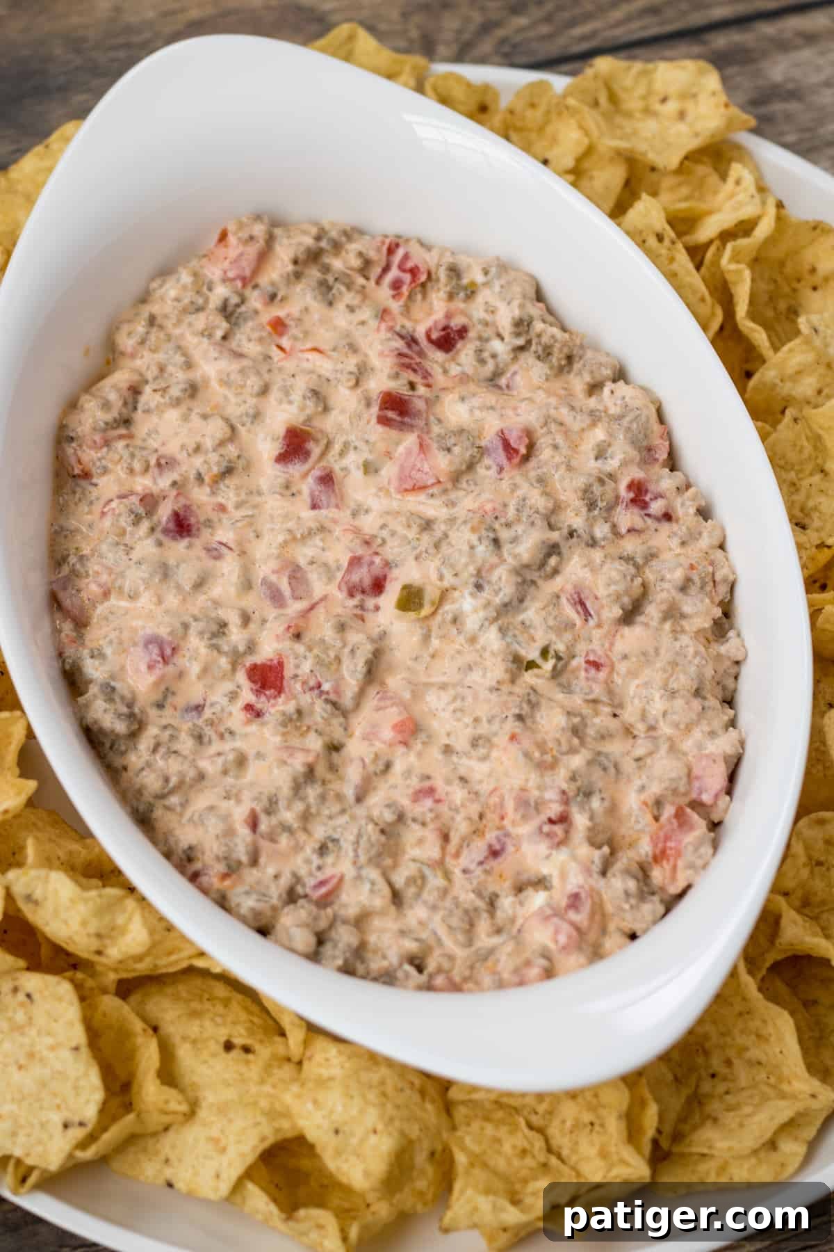 Rotel sausage cream cheese dip served with golden tortilla chips for dipping