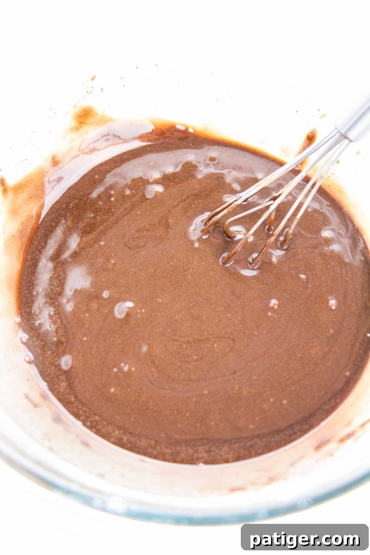 Choco-Biscuit Bliss Bites 8 Chocolate glaze in glass bowl with wire whisk