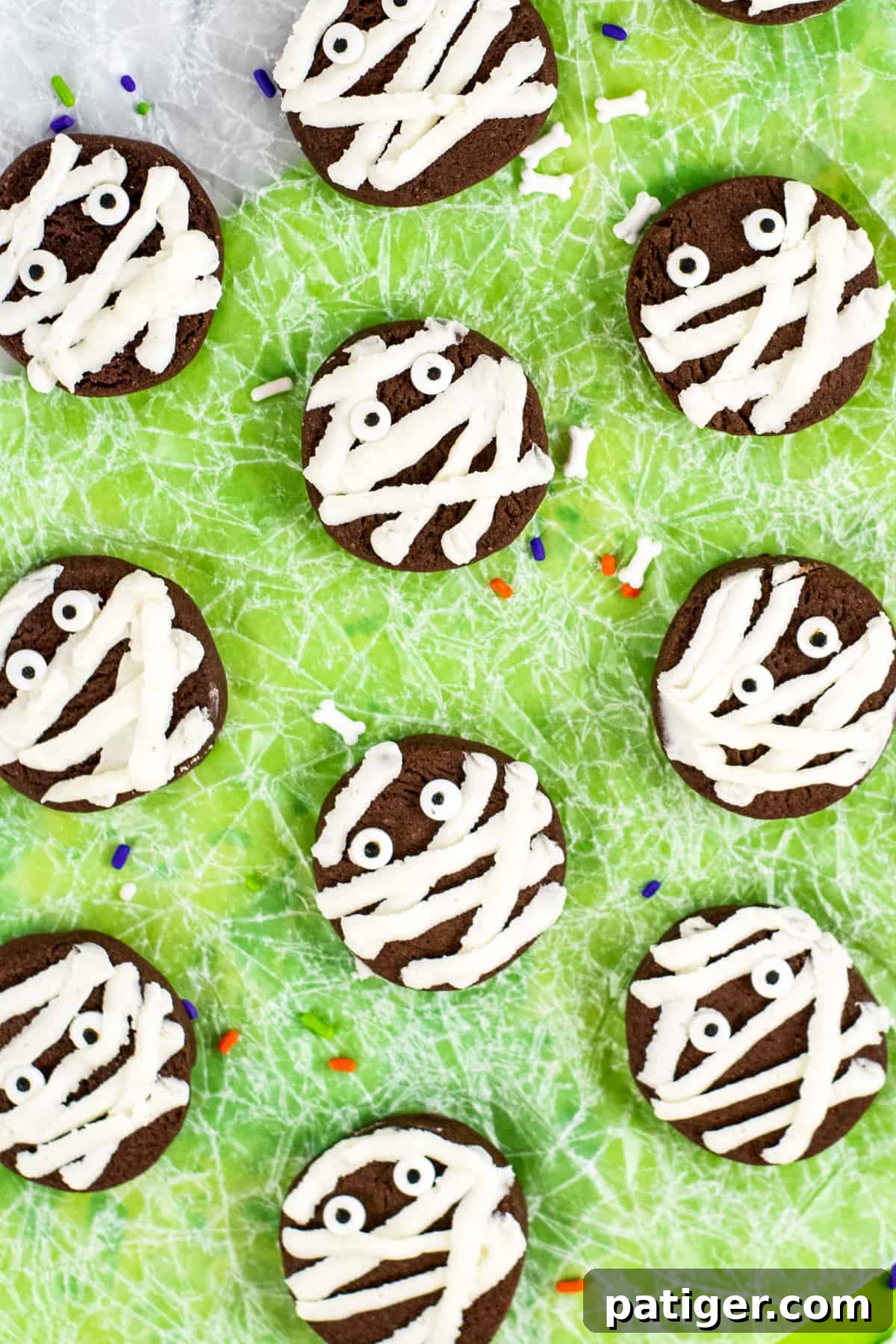 chocolate mummy cookies with vanilla frosting and candy eyeballs