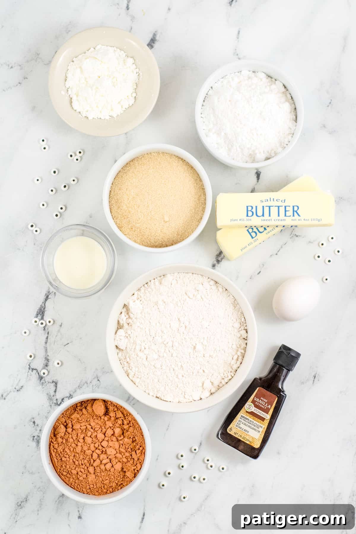 ingredients for decorated mummy cookies in bowls on countertop