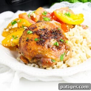 Brown sugar garlic chicken thigh made in the crockpot served over rice with tomato salad