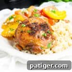 Brown sugar garlic chicken thigh made in the crockpot served over rice with tomato salad
