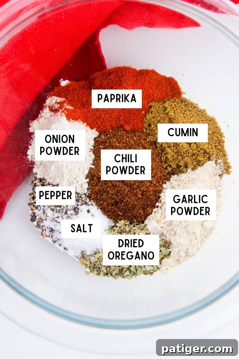 Craft Your Own Chili Spice Blend 4 Ingredients for chili seasoning mix in bowl: paprika, cumin, garlic powder, dried oregano, salt, pepper, chili powder, and onion powder, perfectly laid out before mixing.
