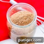 Homemade Chili Seasoning Mix in small glass jar with wire whisk next to it, a miniature image for the callout section.
