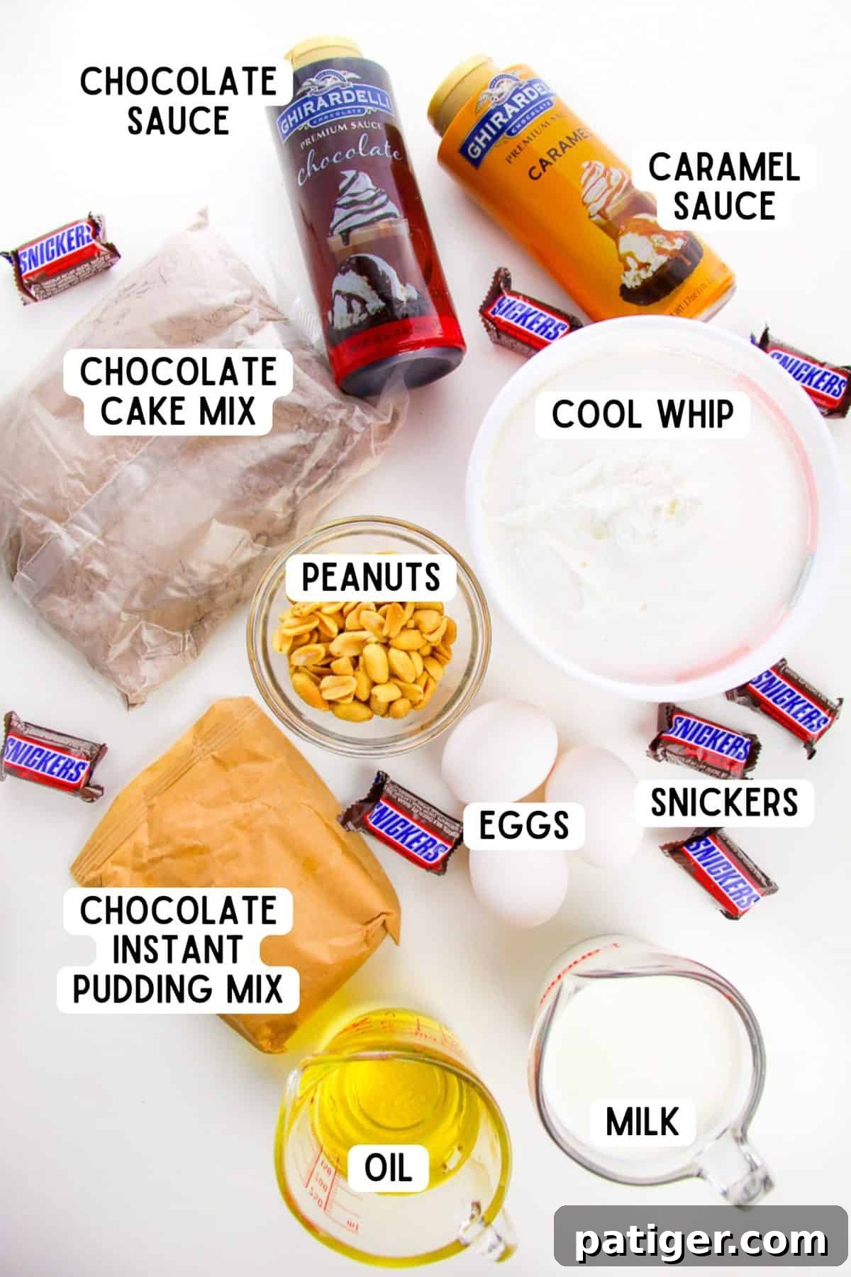 Ingredients for Snickers Poke Cake, including chocolate cake mix, instant pudding, milk, caramel sauce, peanuts, chocolate sauce, cool whip, and Snickers bars.