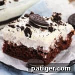 OREO Poke Cake topped with Cool Whip and pieces of OREOs