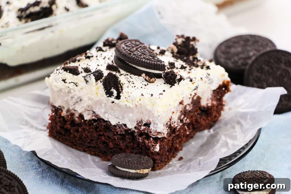 Cookies & Cream Poke Perfection 5 OREO Poke Cake topped with Cool Whip and crumbled OREO cookies