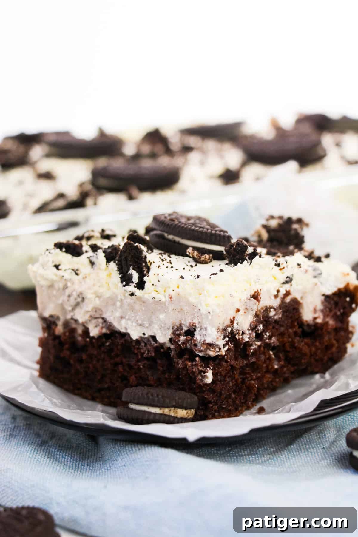 Cookies & Cream Poke Perfection 9 Plate slice of OREO cookie chocolate cake with Cool Whip topping