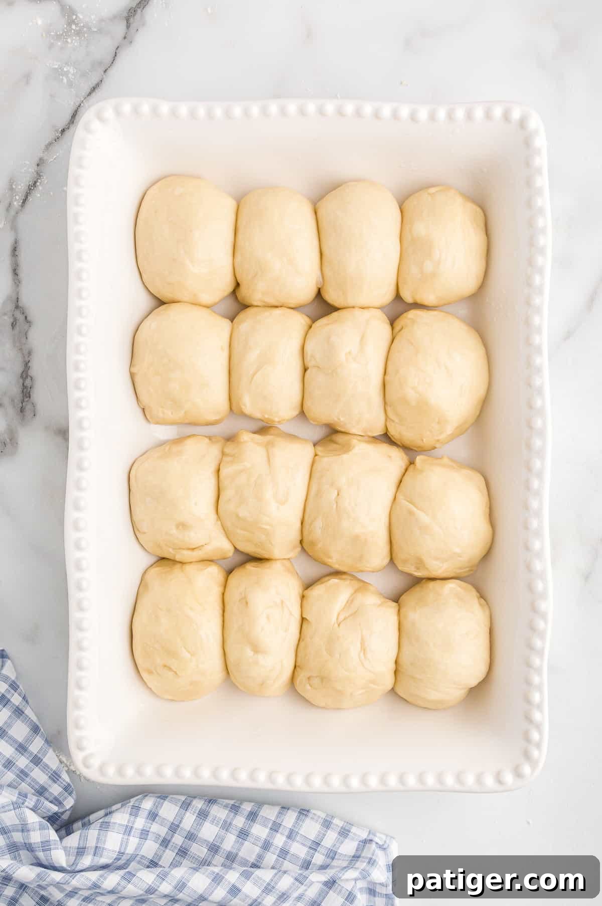 Unbaked potato roll buns in baking dish