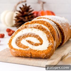 Pumpkin roll cake with cream cheese filling, ready to serve.