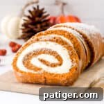Small pumpkin roll cake with cream cheese filling.