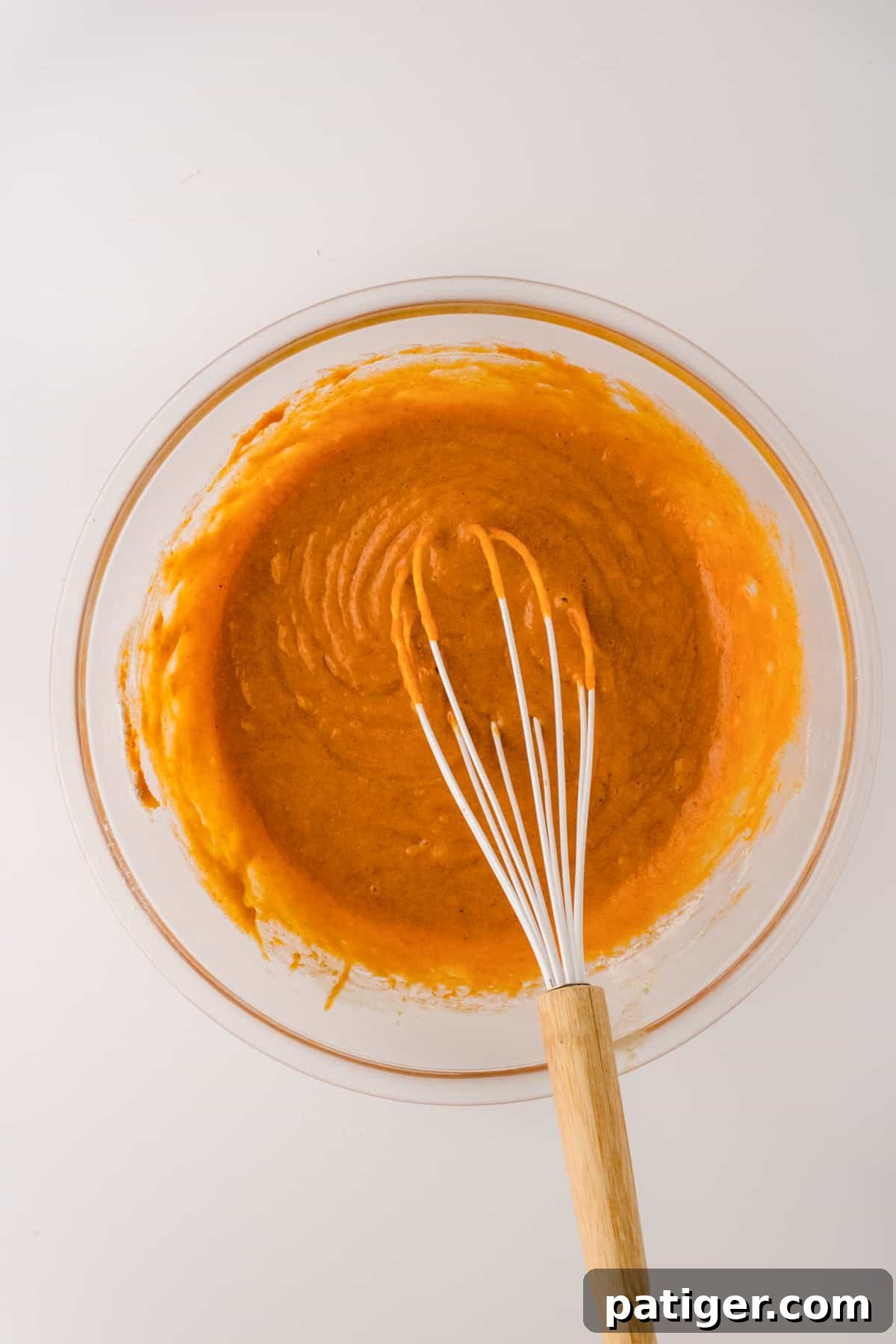 Spiced Pumpkin Swirl Cake 4 Smooth pumpkin batter in a glass bowl, ready for baking.
