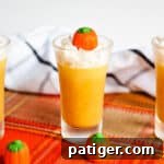 Pumpkin jello shot topped with whipped cream and candy pumpkin