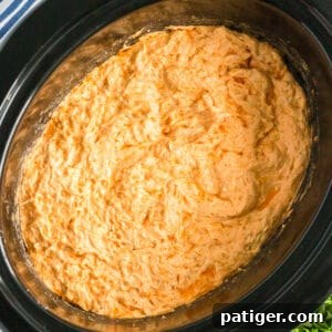 Buffalo chicken dip in the crockpot, close up, showing its creamy texture.