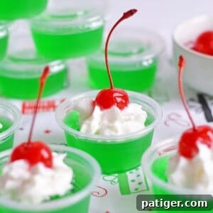 How the Grinch Stole Shots 6 Grinch Jello Shots made with lime jello, tequila, and topped with whipped cream and a maraschino cherry.