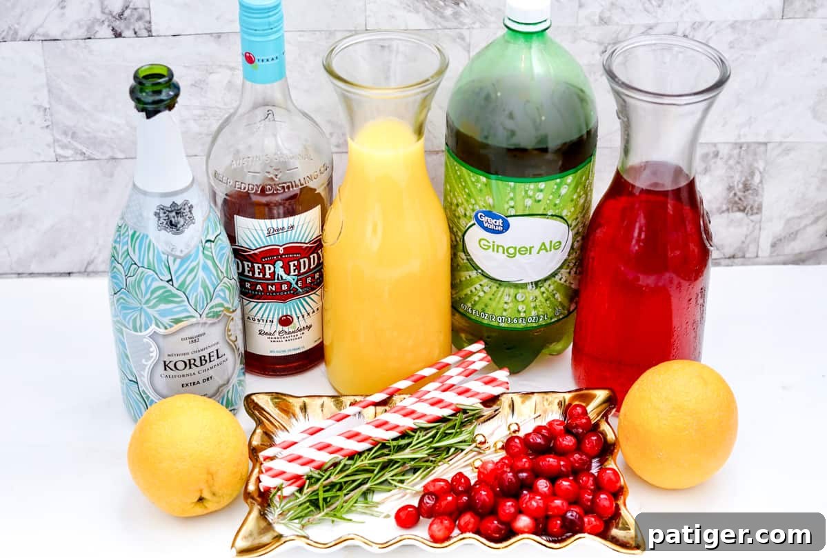 Yuletide Elixir 4 bottles of extra dry korbel champagne, cranberry vodka, orange juice, ginger ale, cranberry and juice on countertop. In front of the bottles are two oranges, a handful of fresh cranberries, a few sprigs of rosemary, and red and white striped paper straws
