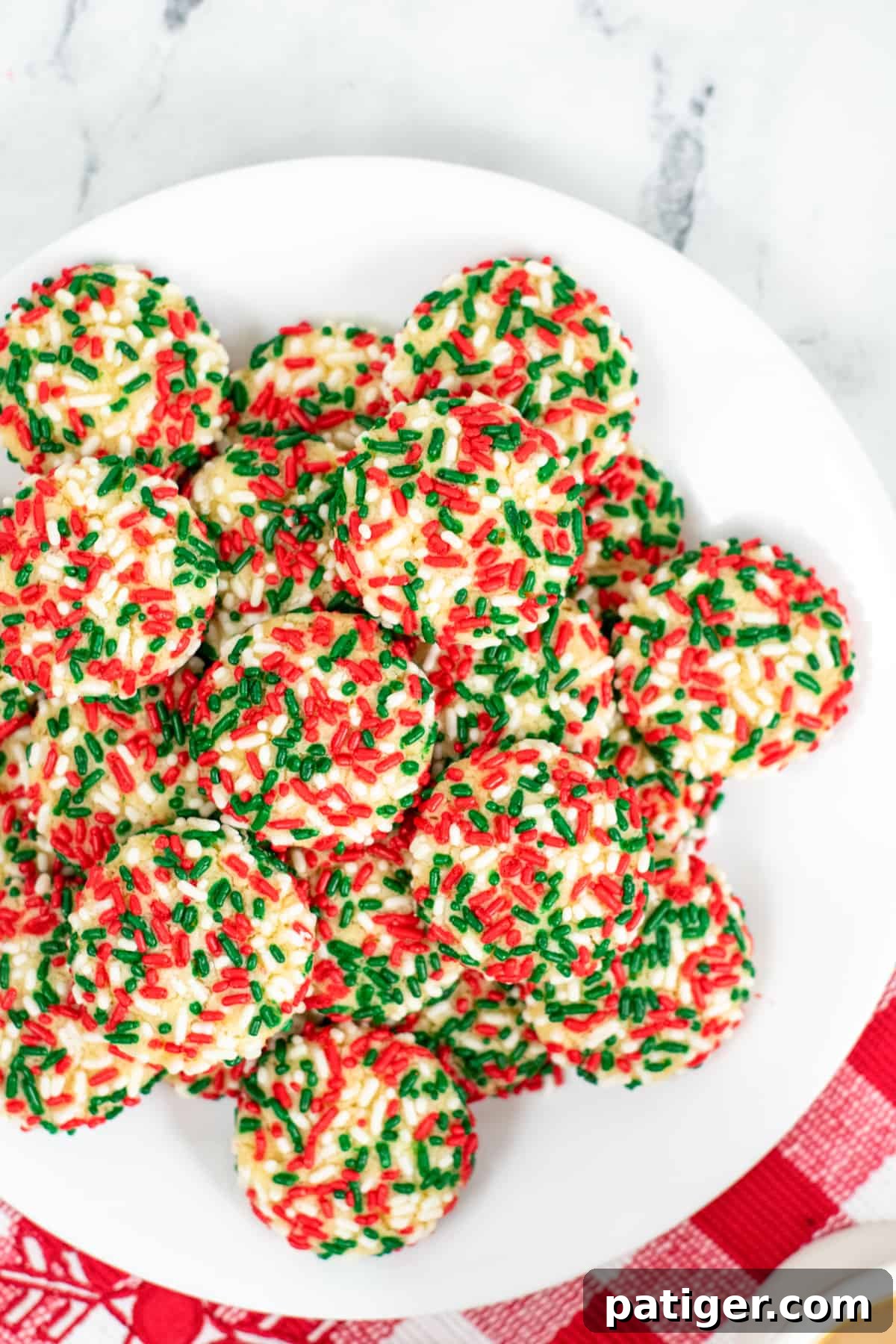 Soft vanilla pudding cookies with Christmas sprinkles on white serving platter