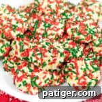 Soft vanilla pudding cookies with Christmas sprinkles on white serving platter