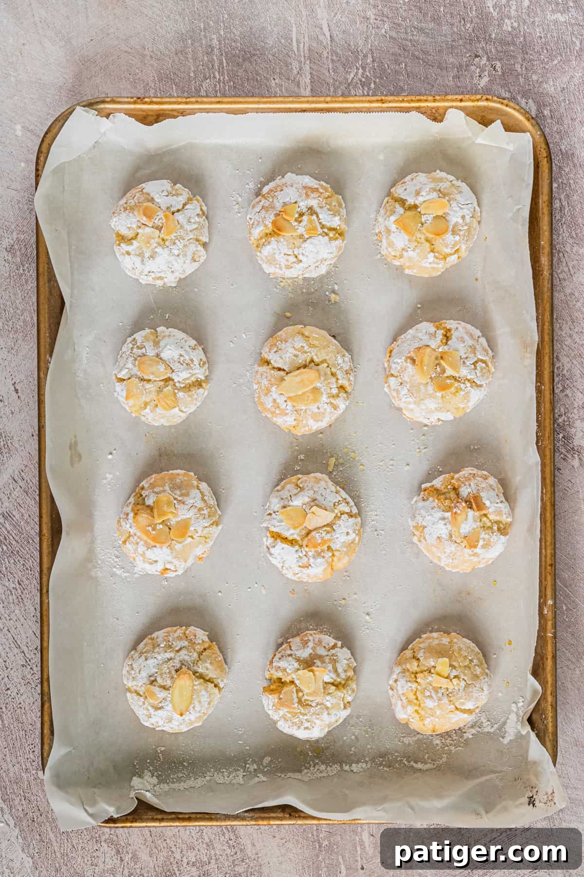 Amaretti cookies on parchment-lined baking sheet