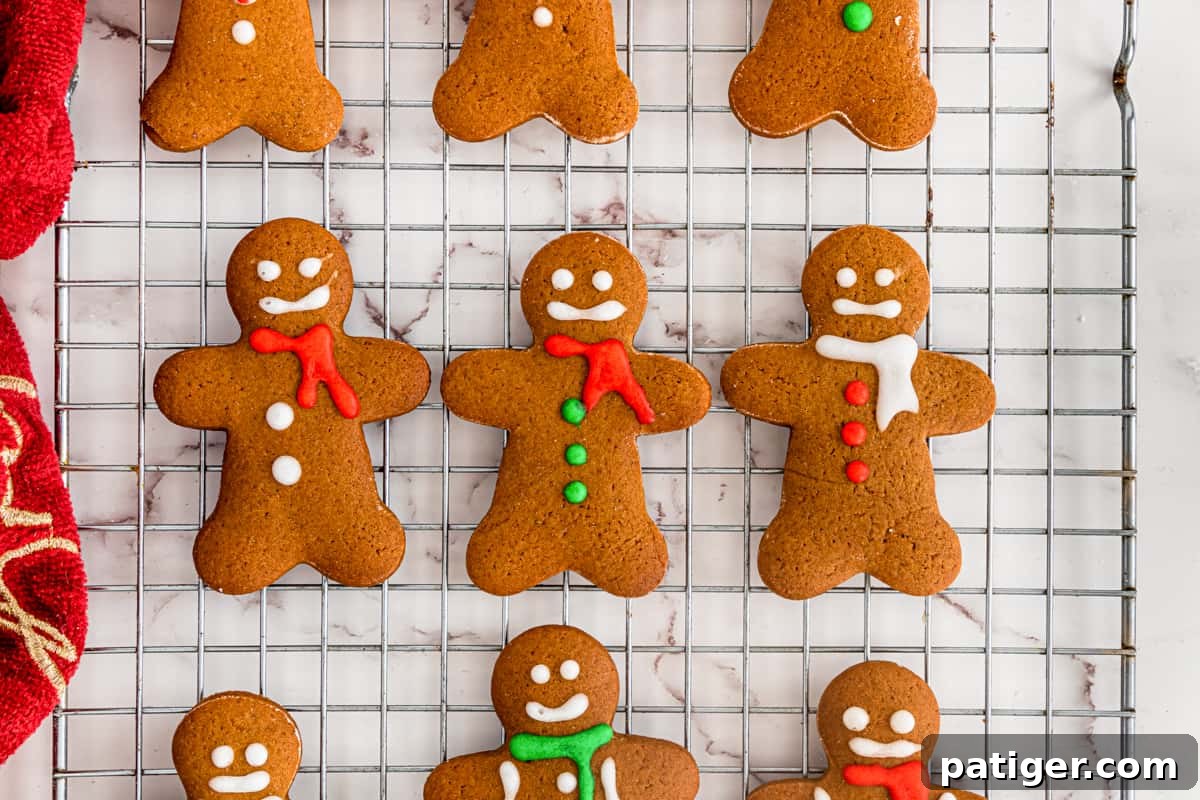 Decorated gingerbread men cookies on cooling rack