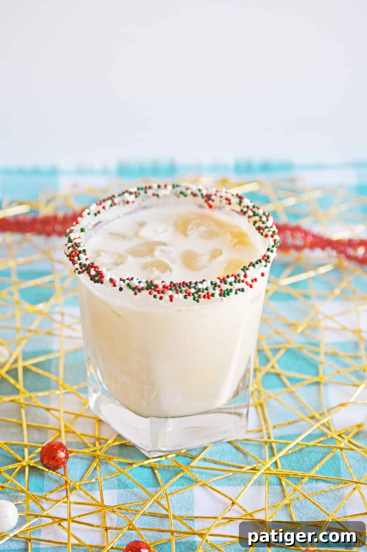 Christmas Cookie Cocktail with vodka in a christmas sprinkle rimmed glass