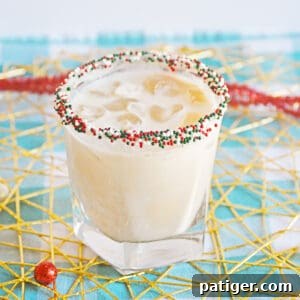 Christmas Cookie Cocktail with vodka in a christmas sprinkle rimmed glass