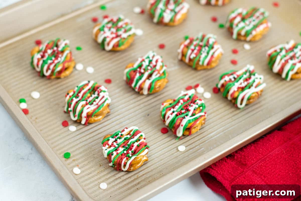 Holiday Pretzel Poppers 3 Neatly arranged rows of Christmas caramel pretzel bites on a serving tray, showcasing the festive colors and sprinkles.