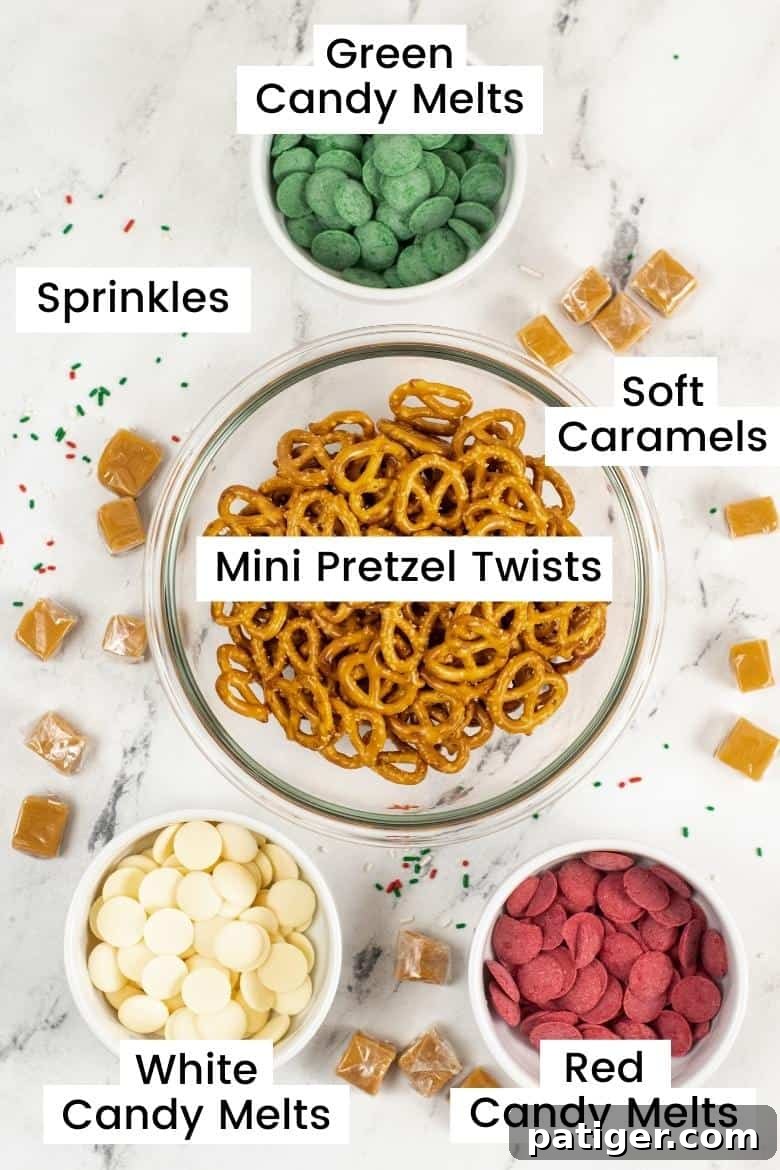 Holiday Pretzel Poppers 4 Labeled ingredients for Christmas Pretzel Bites on a countertop: green candy melts, soft caramels, pretzel twists, red candy melts, white candy melts, and holiday sprinkles.