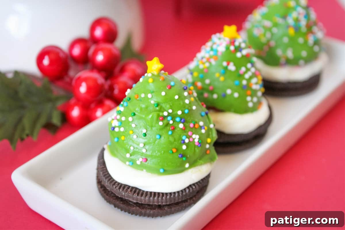 Three Strawberry-Dipped Christmas Tree Treats on white plate