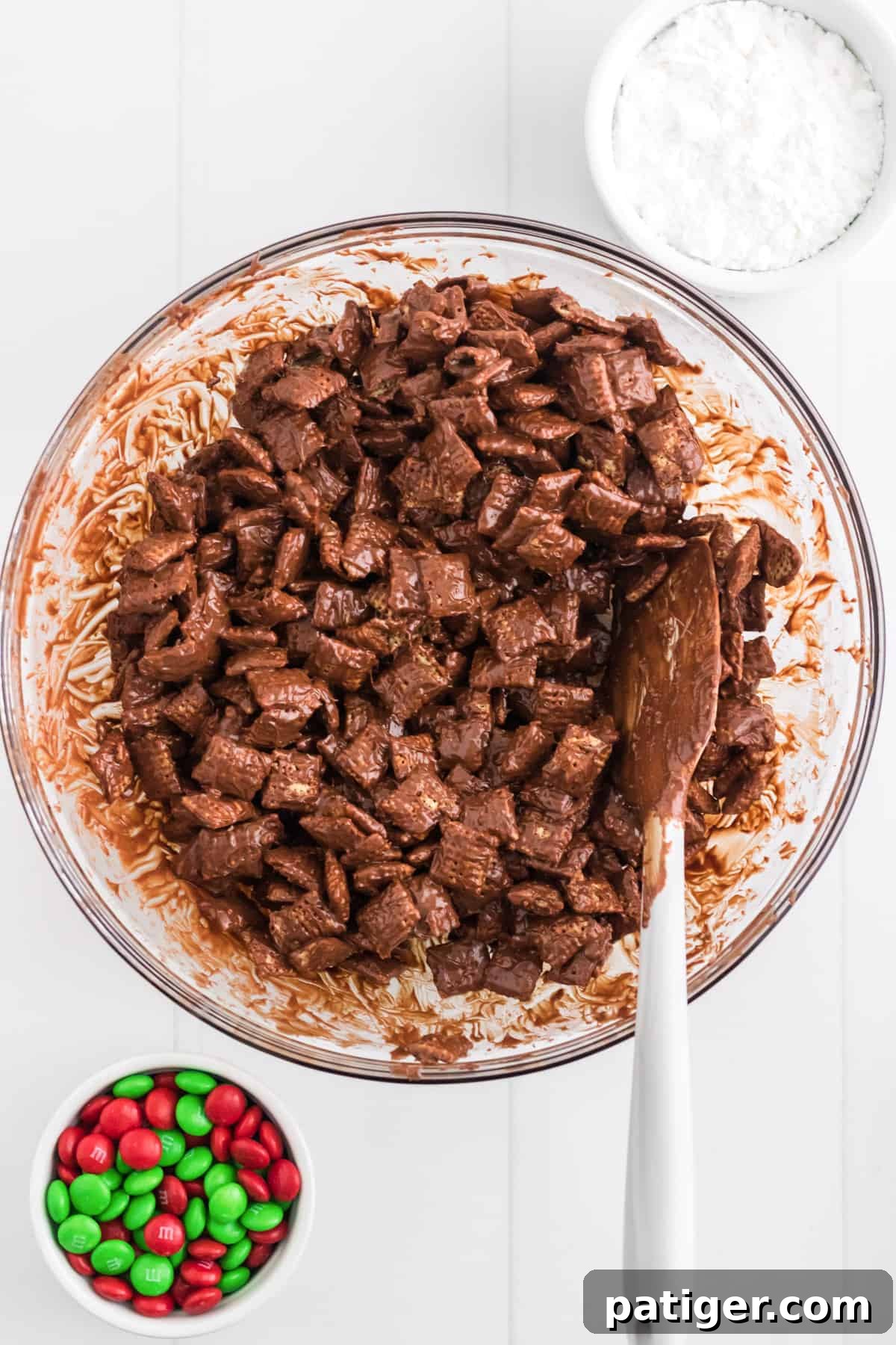 large glass bowl filled with chocolate and peanut butter coated chex cereal