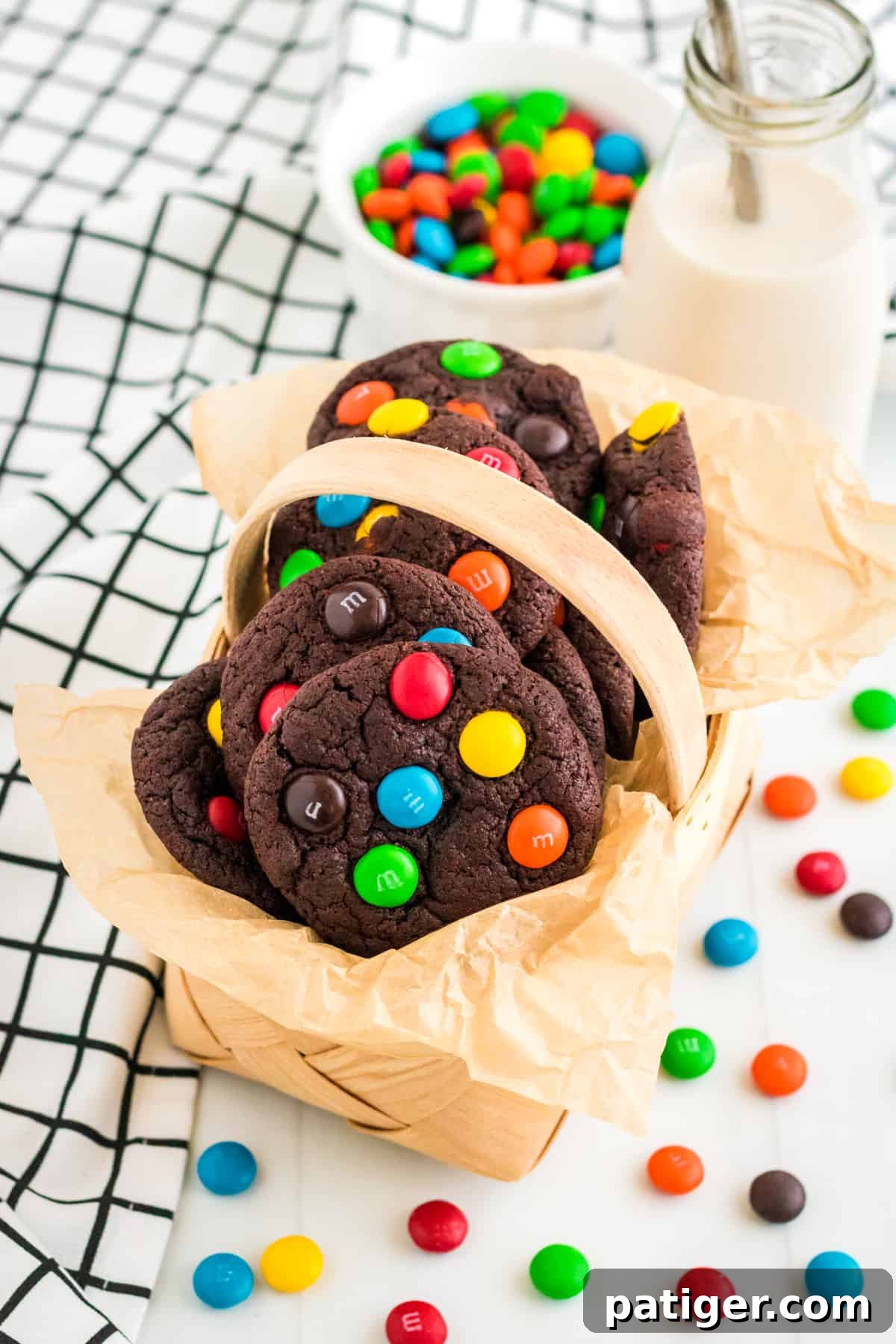 Chocolate M&M cookies in parchment lined basket.