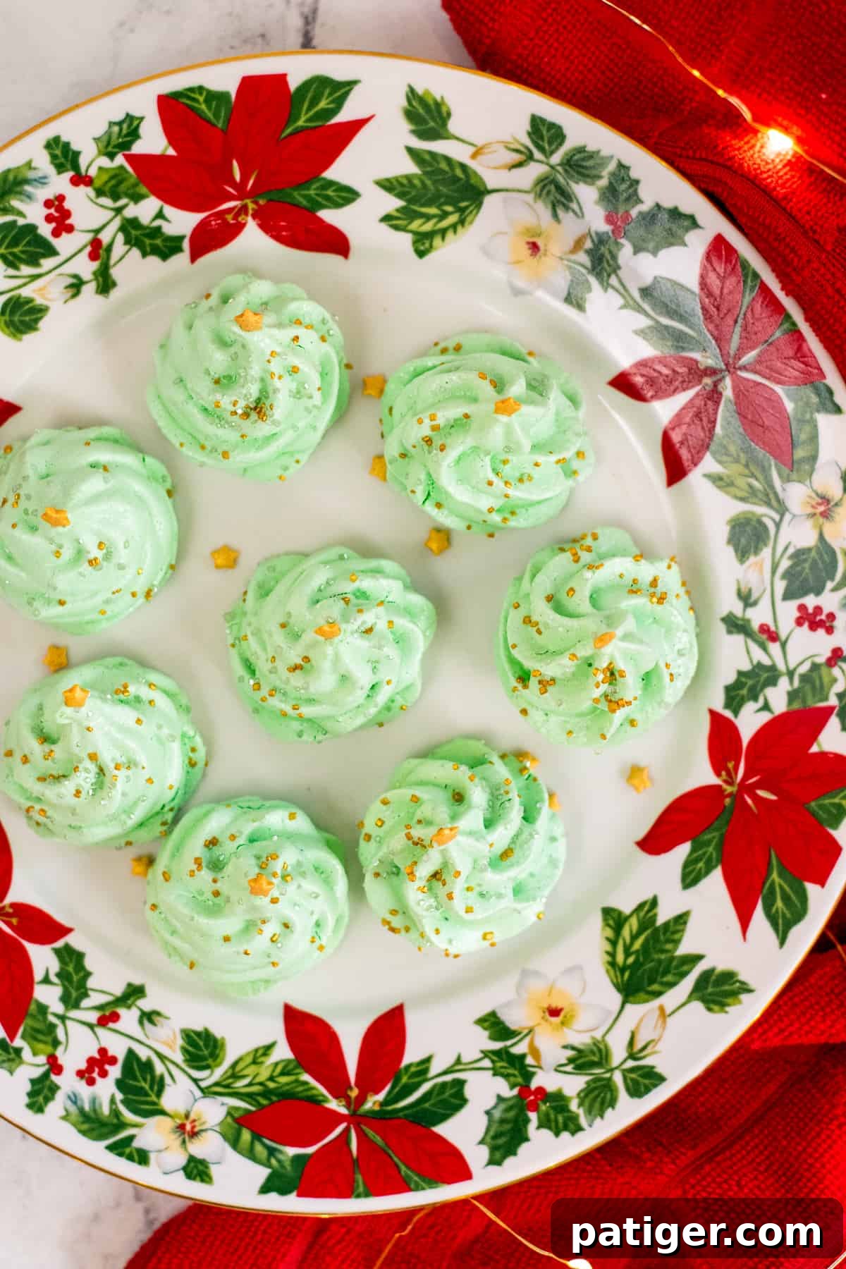 Top-down picture of 7 meringue christmas trees on christmas plate
