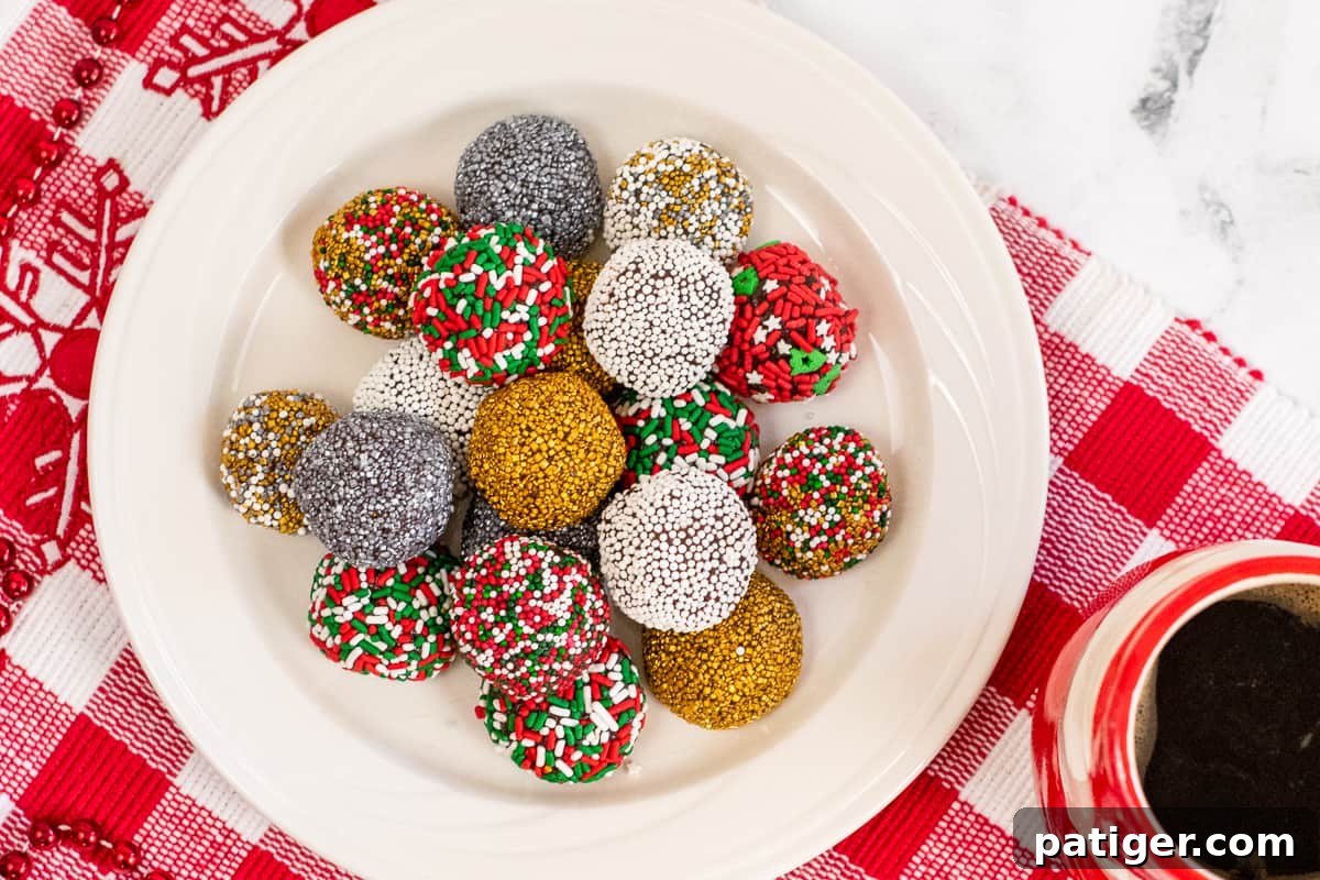 no-bake brownie batter truffles decorated with holiday sprinkles on white plate